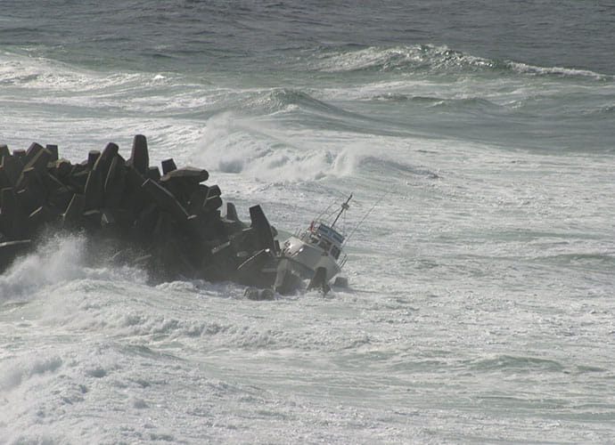 boat washed into headland