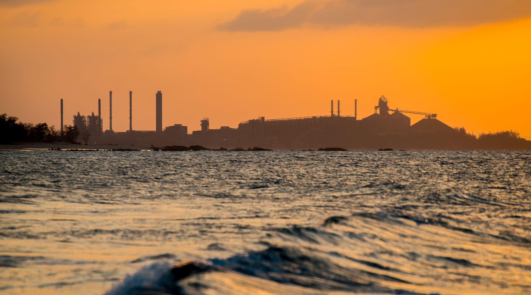 aumina refinery in the distance over bay