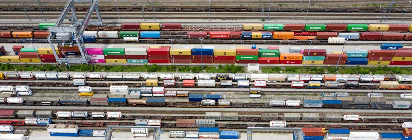 Aerial view of railroad junction, with cargo containers and freight trains.