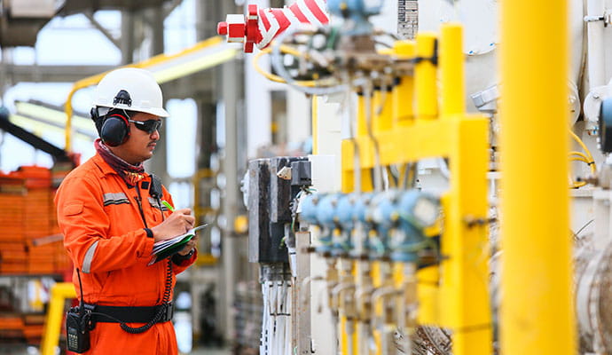 Worker on site inspecting equipment